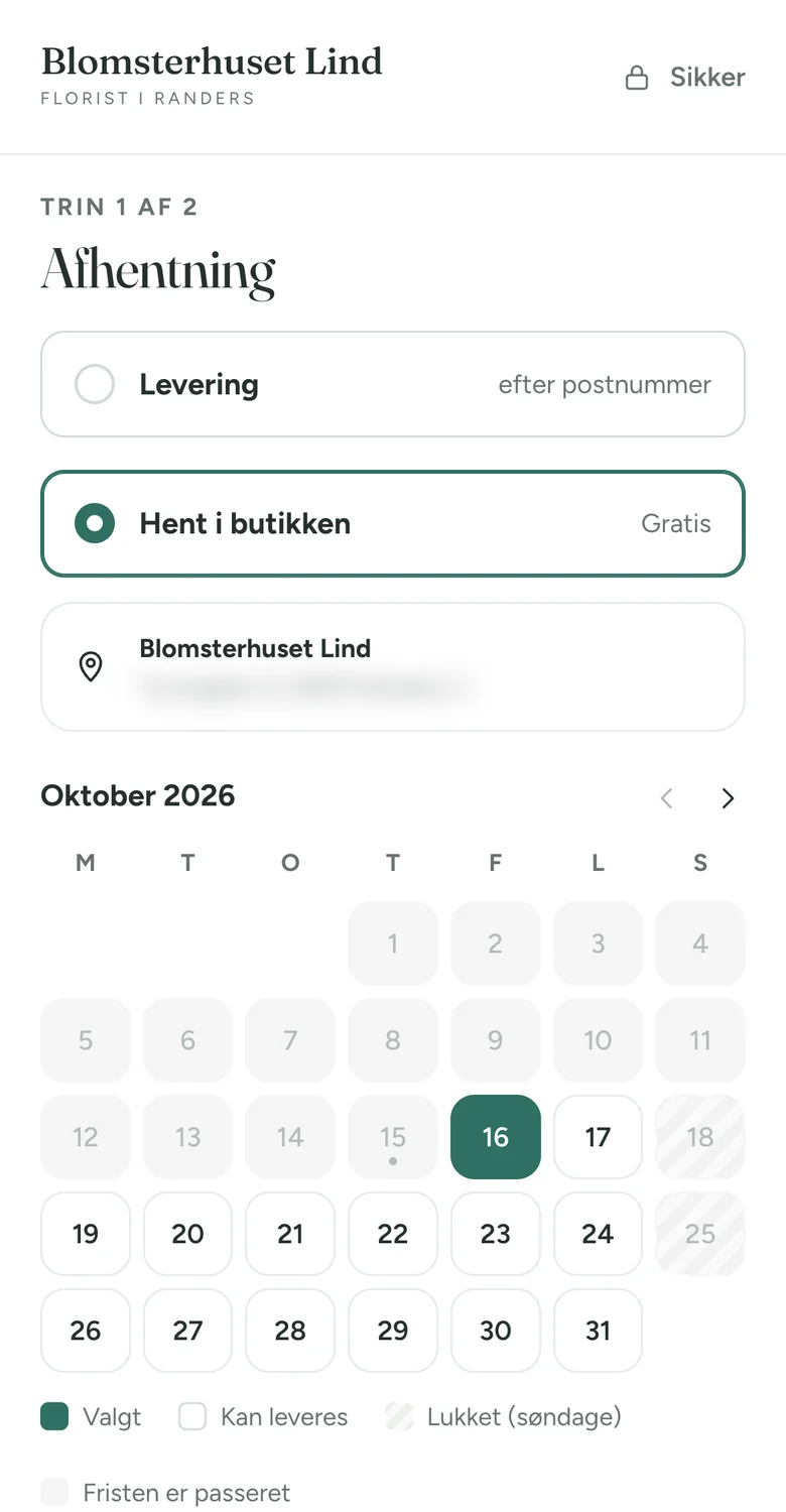 Kassen på en telefon med Hent i butikken valgt, butikkens adresse (sløret) og en kalender, hvor fredag 16. oktober er valgt.
